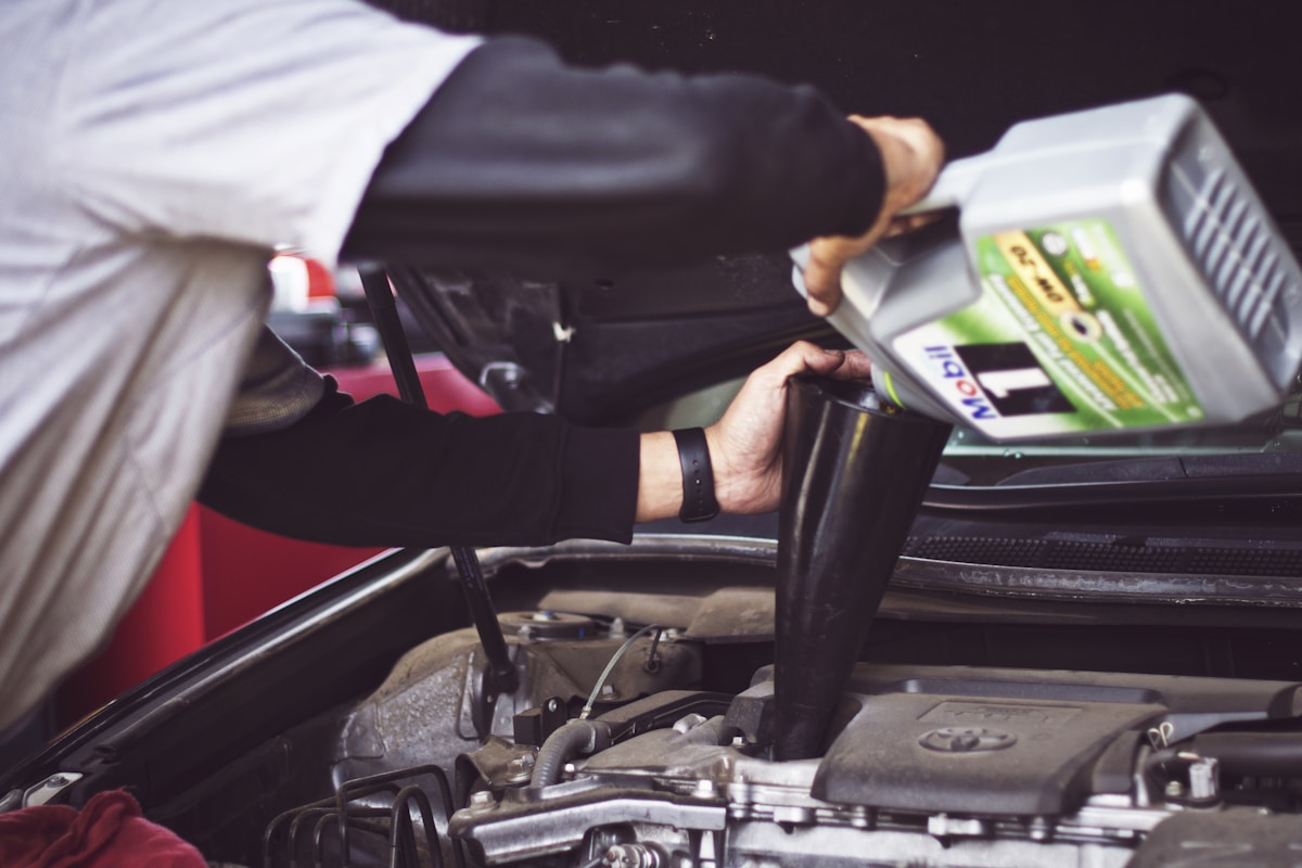 Auto mechanic servicing a car engine